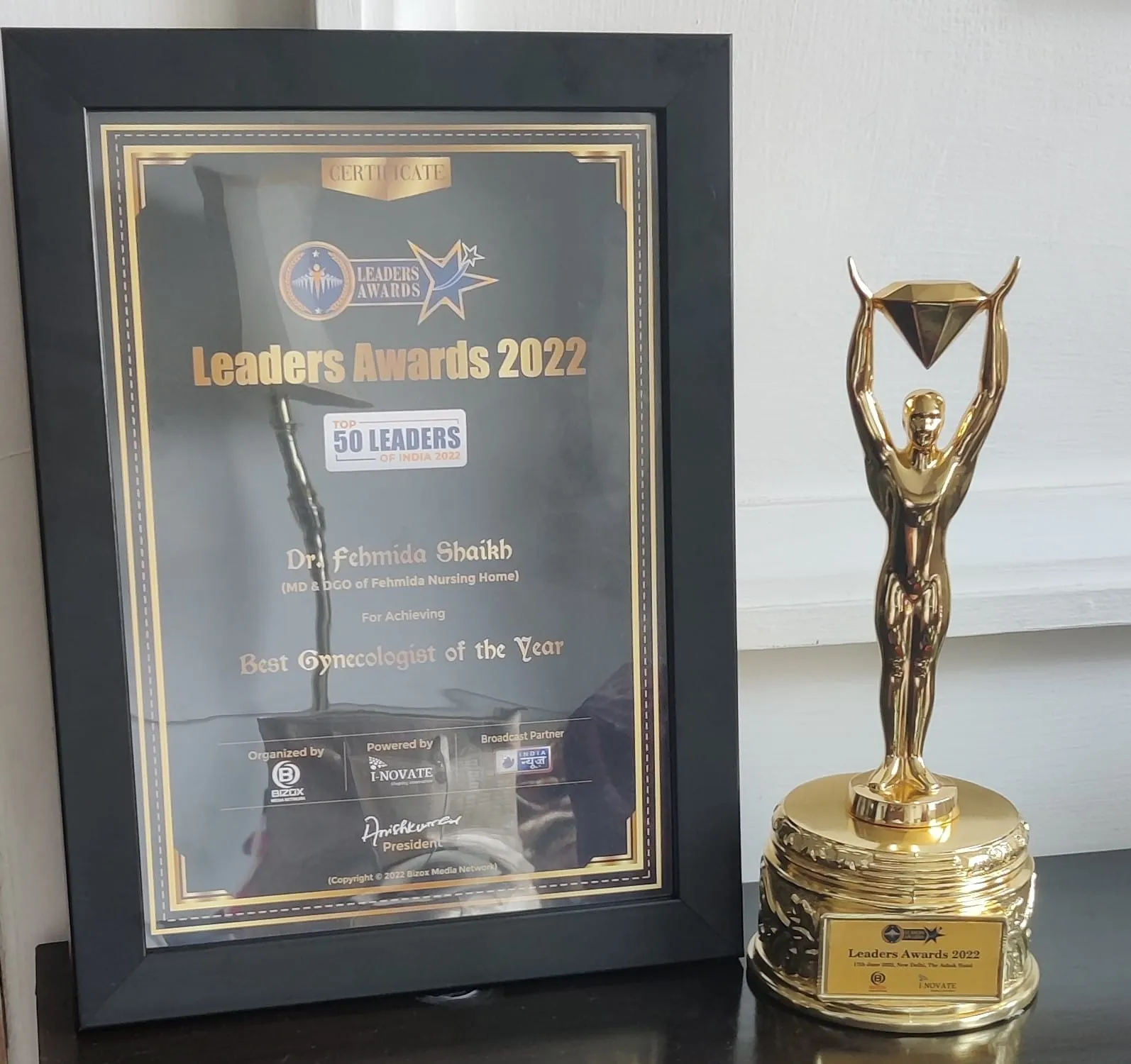 Close-up of the prestigious Leaders Awards Best Gynaecologist certificate and trophy