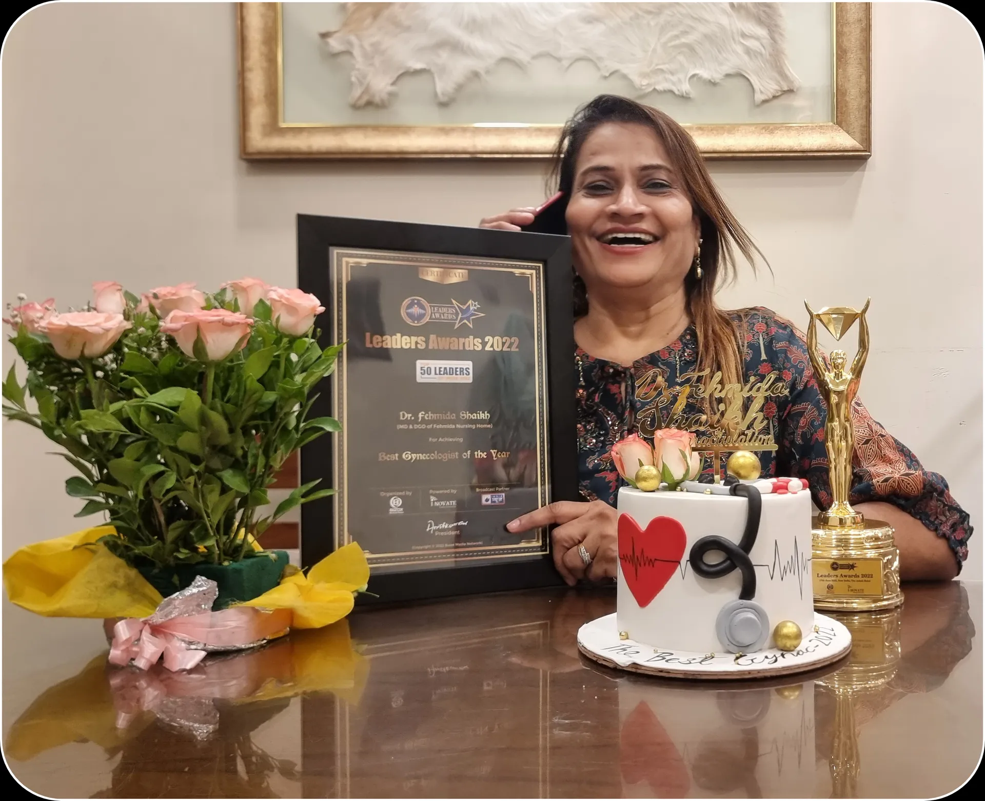 Dr. Fehmida Shaikh with Best Gynaecologist of the Year 2022 trophy, certificate, and custom stethoscope celebration cake
