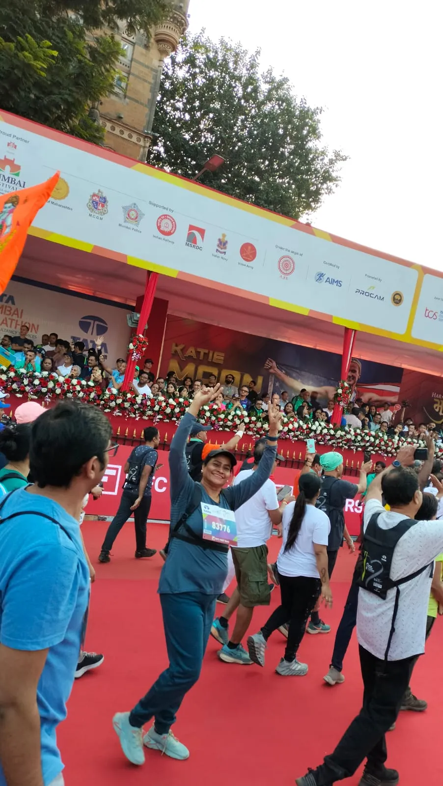 Dr. Fehmida Shaikh in marathon running gear at finish line cheer point