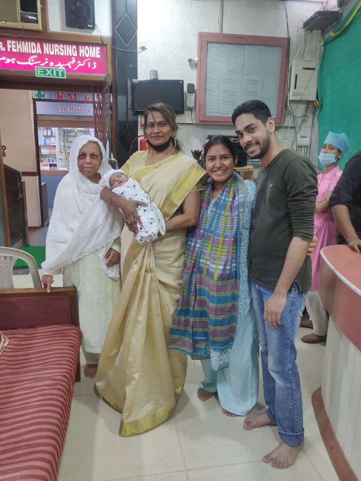 Happy family with newborn baby at Fehmida Nursing Home maternity entrance